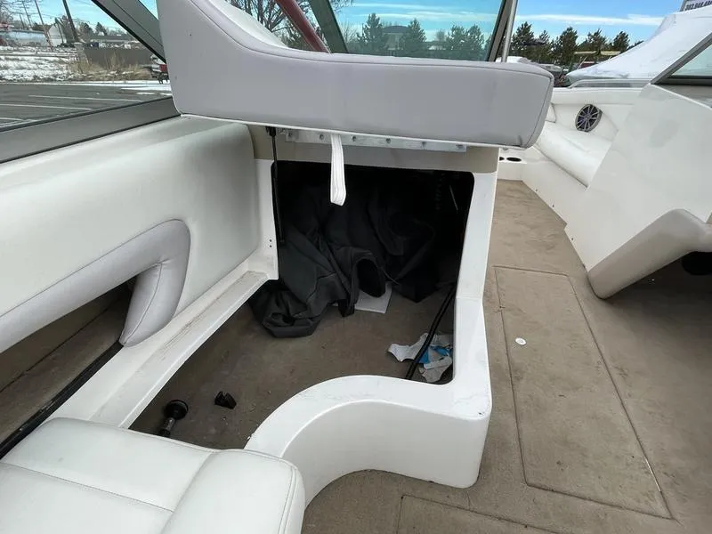 Slide: The Image of 2001 MasterCraft X30 interior with white seating and storage compartment. - 22