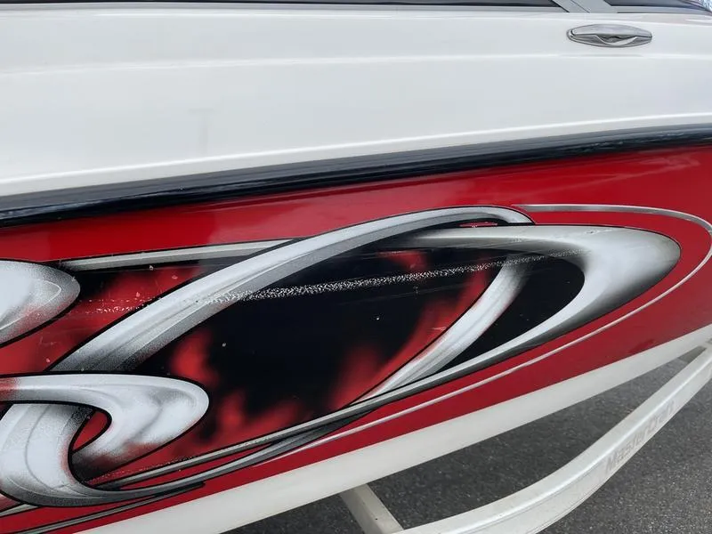 Slide: The Image of 2001 MasterCraft X30 boat with red and black abstract design on the side. - 24