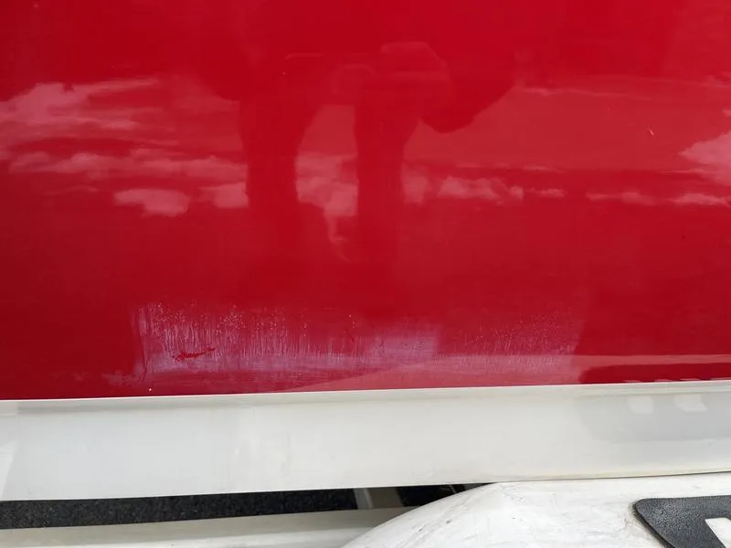 Slide: The Image of Close-up of a 2001 MasterCraft X30 boat's red and white exterior. - 27