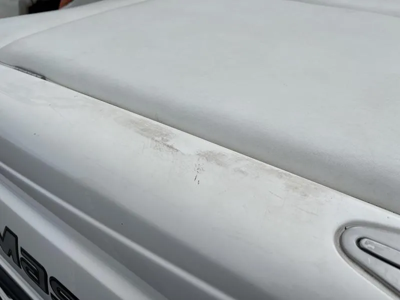 Slide: The Image of Close-up of a 2001 MasterCraft X30 boat's white surface with slight wear. - 29