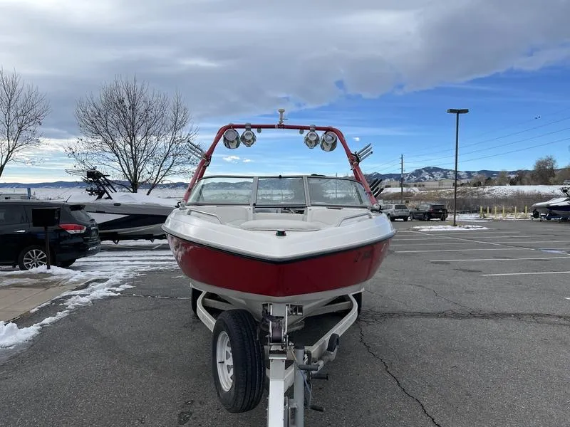 Slide: The Image of 2001 MasterCraft X30 boat on trailer in snowy parking lot. - 3