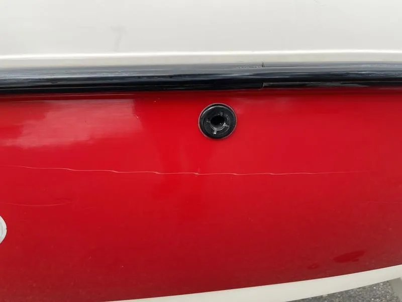 Slide: The Image of Red and white 2001 MasterCraft X30 boat hull detail. - 31