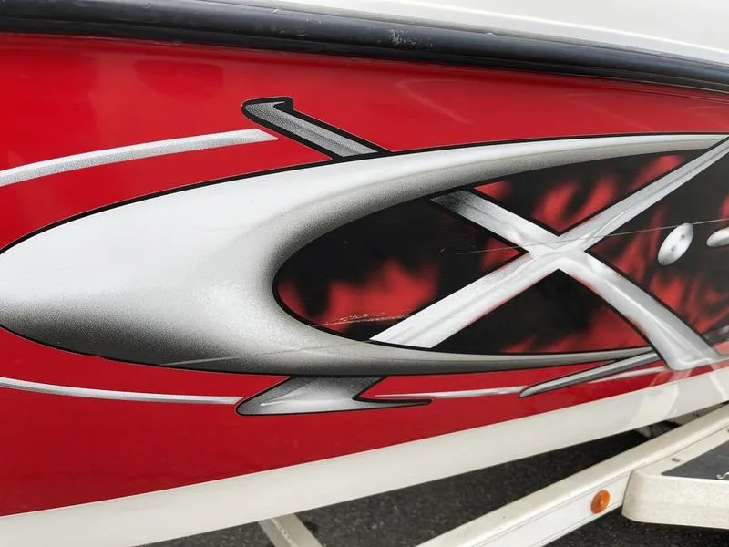 Slide: The Image of Close-up of 2001 MasterCraft X30 boat with red and black graphic design. - 32
