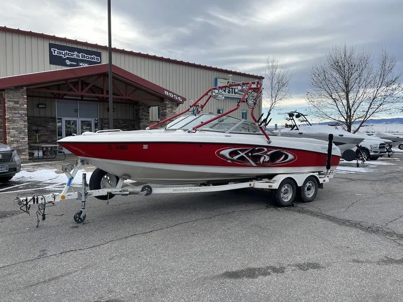 Slide: The Image of 2001 MasterCraft X30 boat on trailer outside dealership. - 4