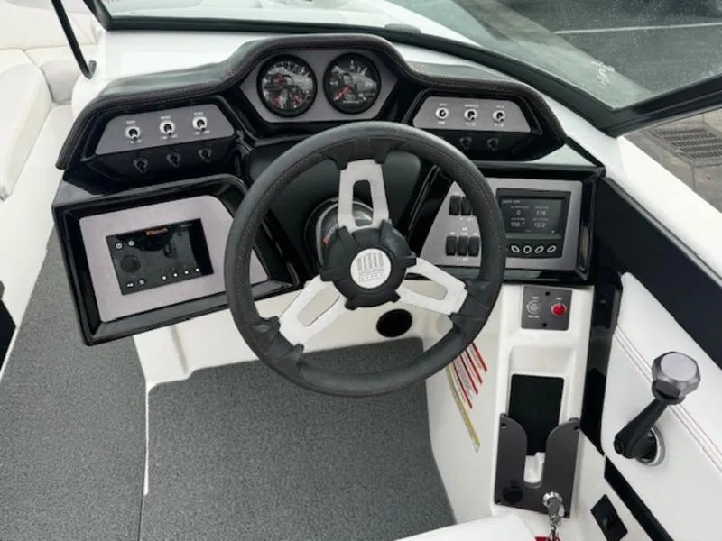 Slide: The Image of 2021 MasterCraft NXT22 boat dashboard with steering wheel and control panel. - 10