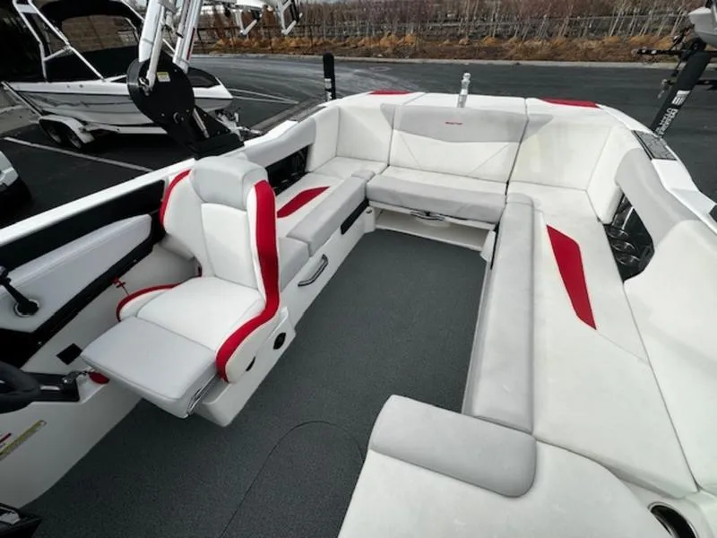 Slide: The Image of 2021 MasterCraft NXT22 boat interior with white and red seating, spacious layout. - 13