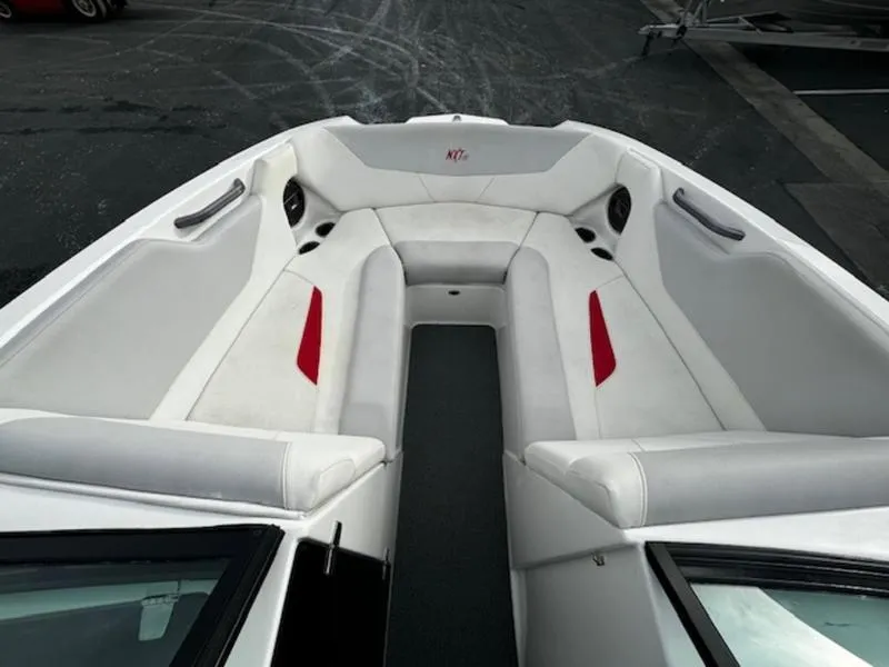 Slide: The Image of 2021 MasterCraft NXT22 boat interior with white and red seating. - 14
