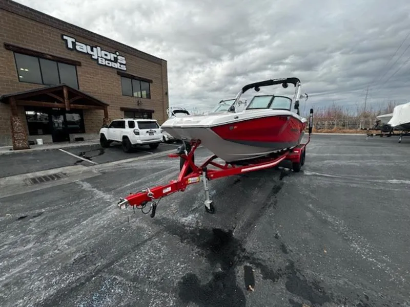 Slide: The Image of 2021 MasterCraft NXT22 boat on red trailer outside Taylor's Boats dealership. - 3