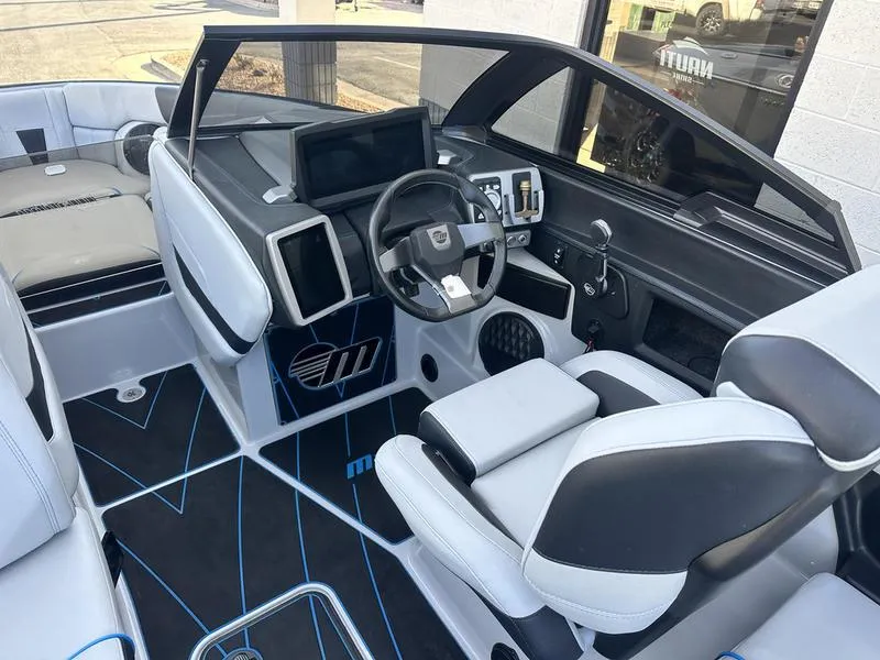 Slide: The Image of 2023 Malibu 23 LSV boat interior with modern dashboard and seating. - 10