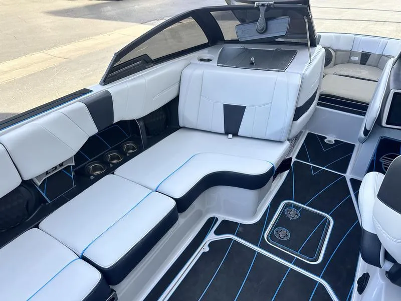 Slide: The Image of 2023 Malibu 23 LSV boat interior with sleek white and black seating. - 11