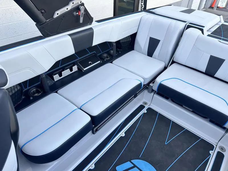 Slide: The Image of 2023 Malibu 23 LSV boat interior with sleek seating and modern design. - 13