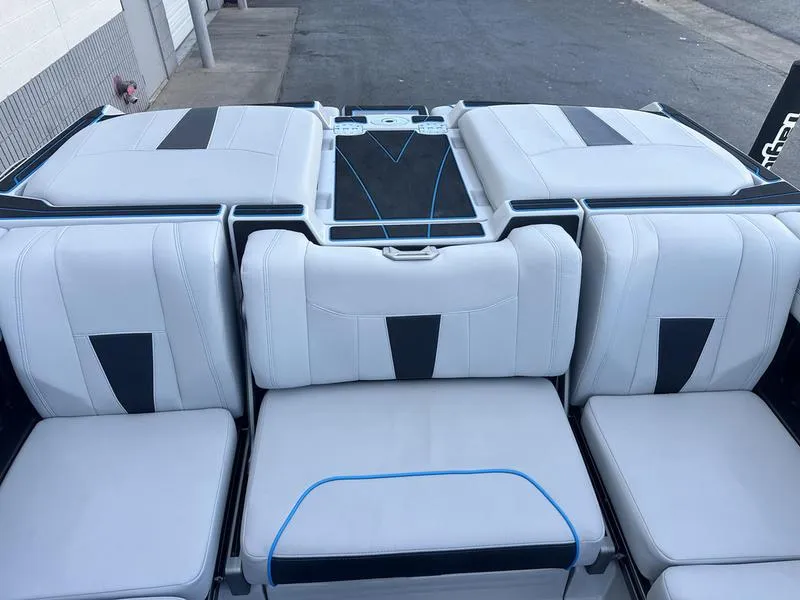 Slide: The Image of 2023 Malibu 23 LSV boat interior with sleek white and black seating. - 14