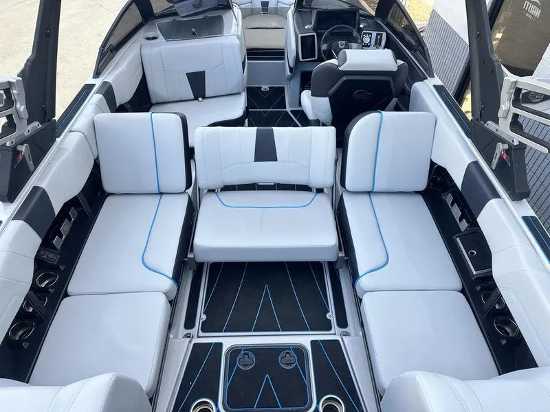 Slide: The Image of 2023 Malibu 23 LSV boat interior with white seating and modern design. - 15