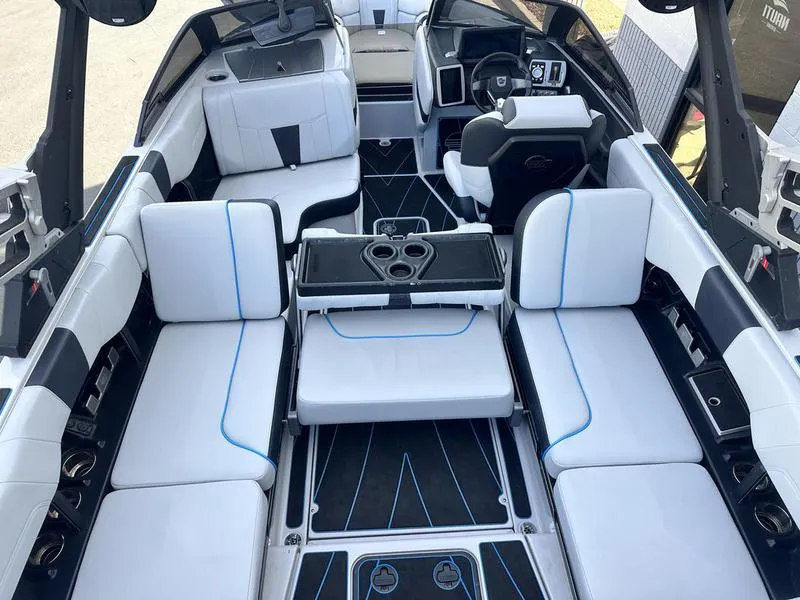 Slide: The Image of 2023 Malibu 23 LSV boat interior with white seating and modern dashboard. - 16