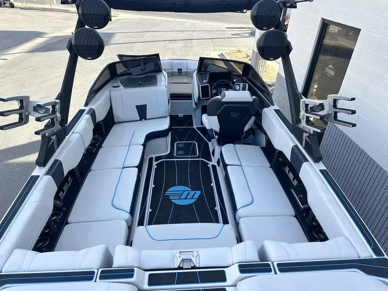 Slide: The Image of 2023 Malibu 23 LSV boat interior with white seating and black accents. - 9