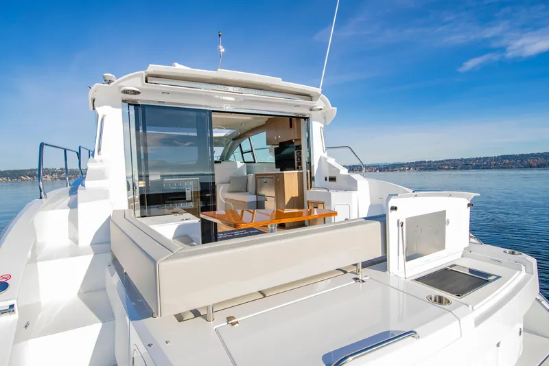 Slide: The Image of 2025 Cruisers Yachts 46 Cantius, luxury deck view, modern design, open water backdrop. - 14