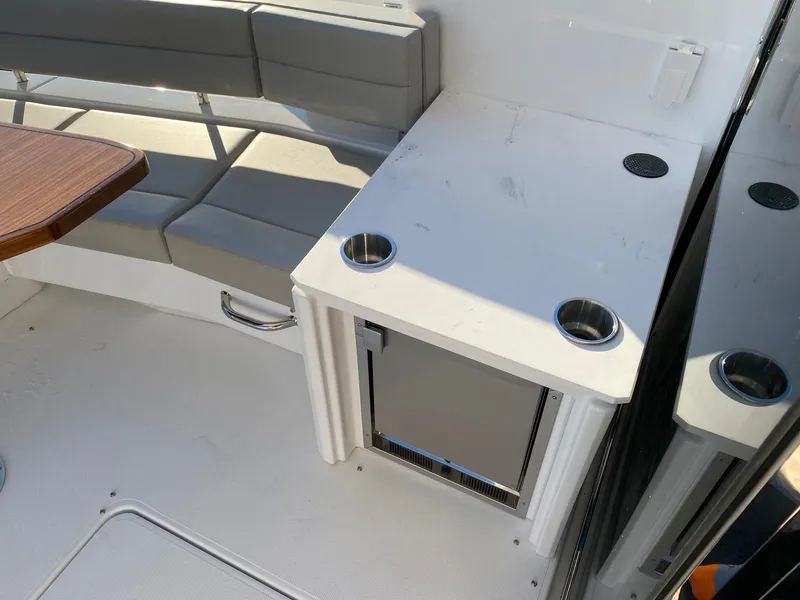 Slide: The Image of 2025 Cruisers Yachts 46 Cantius interior with seating and mini fridge. - 20