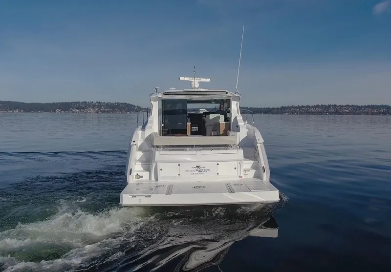 Slide: The Image of 2025 Cruisers Yachts 46 Cantius on calm water, rear view. - 3