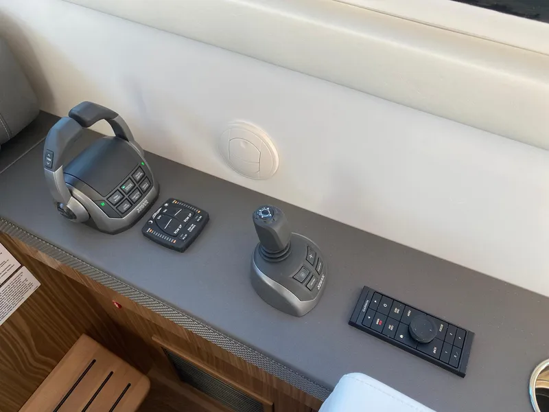 Slide: The Image of Control panel of 2025 Cruisers Yachts 46 Cantius, featuring joystick and throttle controls. - 31