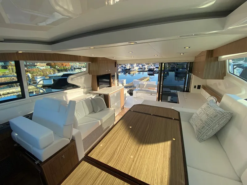 Slide: The Image of Luxurious interior of 2025 Cruisers Yachts 46 Cantius with modern furnishings and marina view. - 33