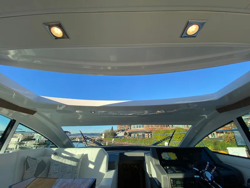 Slide: The Image of 2025 Cruisers Yachts 46 Cantius interior with panoramic sunroof and modern helm. - 35