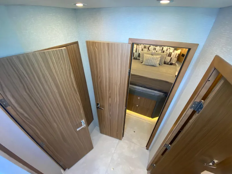 Slide: The Image of Interior of 2025 Cruisers Yachts 46 Cantius, featuring modern wood doors and cozy bedroom. - 39