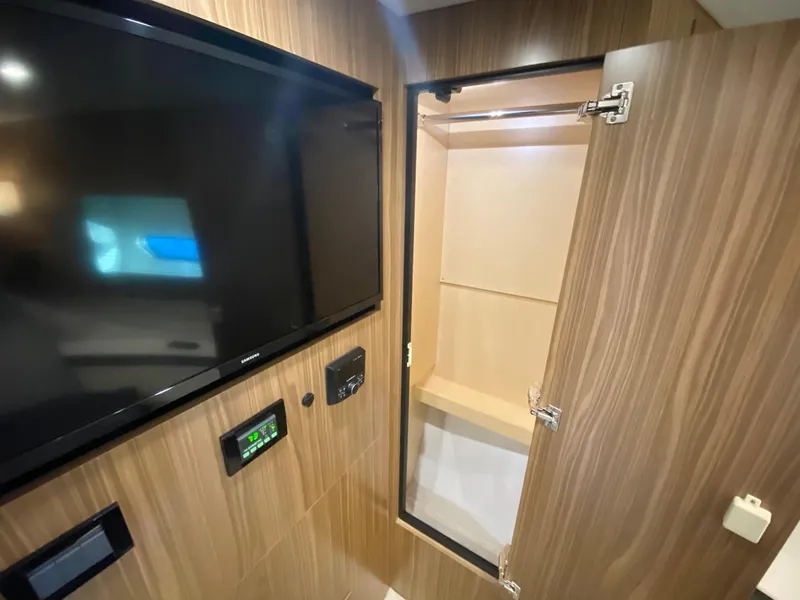 Slide: The Image of 2025 Cruisers Yachts 46 Cantius interior with TV and open cabinet. - 44