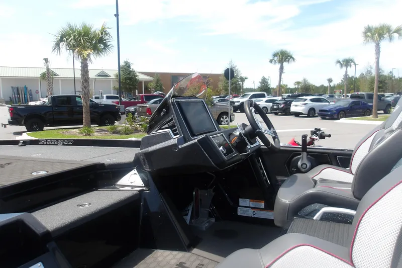 Slide: The Image of 2025 Ranger Z520R Cup-Equipped boat interior with modern dashboard and seating in a parking lot. - 5
