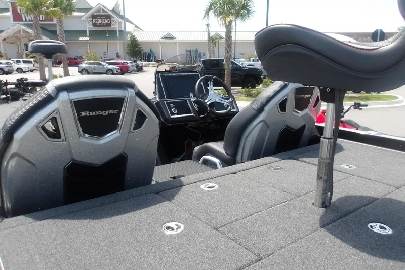 Slide: The Image of 2025 Ranger Z520R Cup-Equipped boat interior with seats and dashboard, parked outdoors. - 18