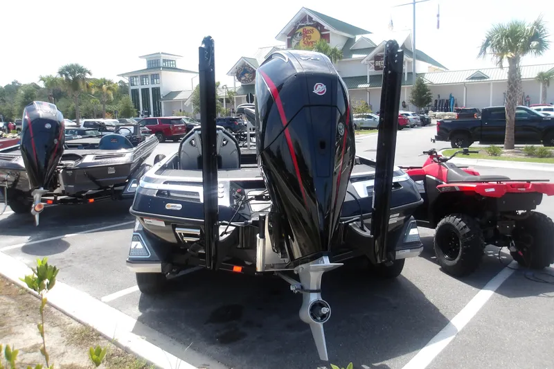 Slide: The Image of 2025 Ranger Z520R Cup-Equipped boat parked near a store, alongside an ATV. - 17