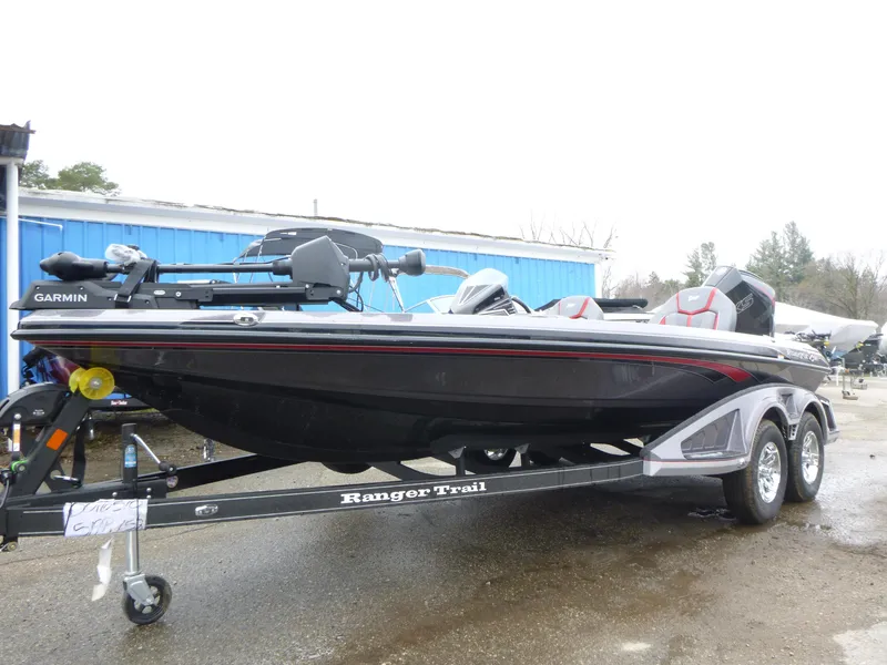 Slide: The Image of 2025 Ranger Z519R Cup-Equipped boat on trailer, featuring Garmin equipment, parked outdoors. - 2