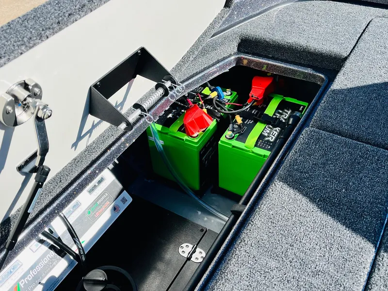 Slide: The Image of 2025 Ranger Z520R Cup-Equipped boat battery compartment with green batteries and wiring. - 48