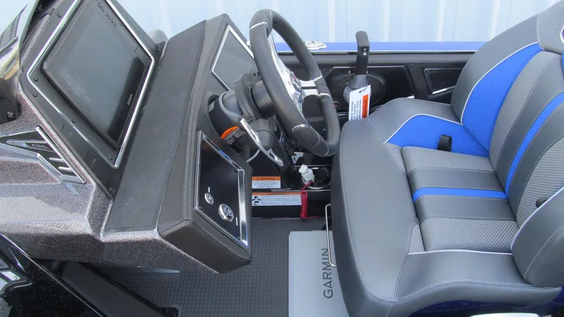 Slide: The Image of 2025 Ranger Z520R Cup-Equipped boat interior with steering wheel and Garmin display. - 13
