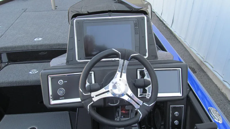 Slide: The Image of 2025 Ranger Z520R Cup-Equipped boat dashboard with steering wheel and digital displays. - 6