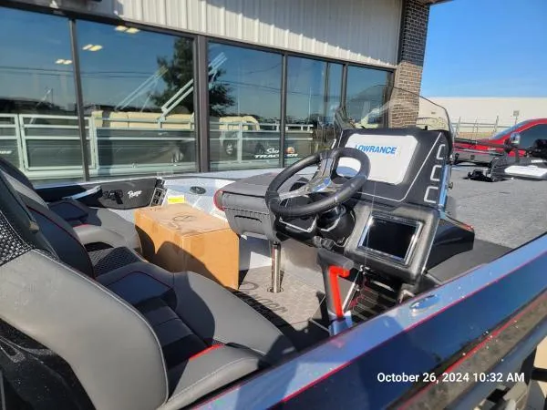 Slide: The Image of 2025 Ranger Z519R Cup-Equipped boat interior with steering wheel and electronics display. - 3