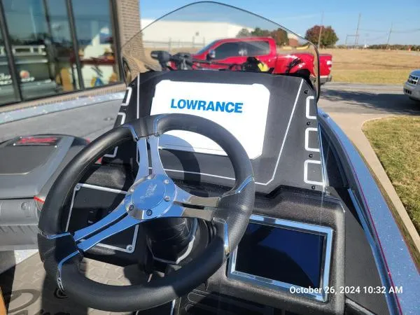 Slide: The Image of 2025 Ranger Z519R Cup-Equipped boat dashboard with Lowrance display and steering wheel. - 4