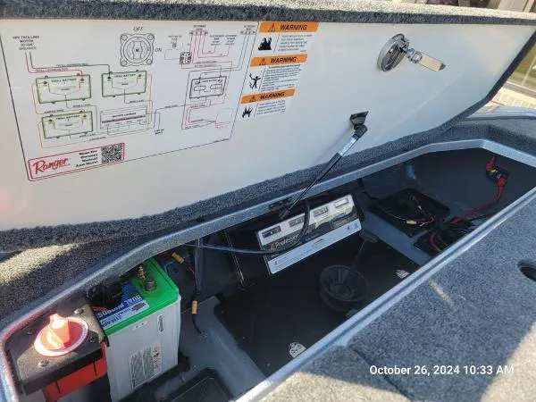 Slide: The Image of 2025 Ranger Z519R Cup-Equipped boat battery compartment with wiring diagram and warning labels. - 9