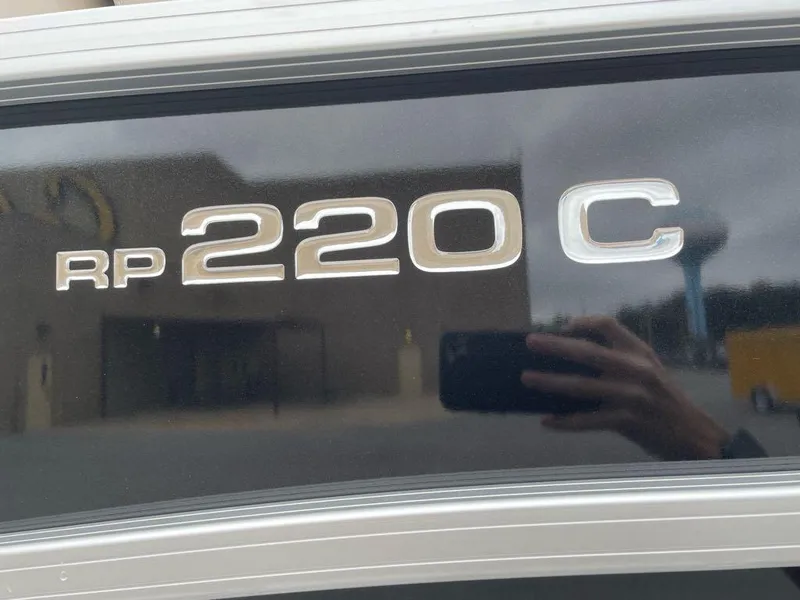 Slide: The Image of Close-up of Ranger Reata 220C 2025 model emblem on a reflective surface. - 2