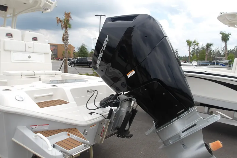 Slide: The Image of 2025 Ranger 2600 Bay boat with Mercury outboard motor in a parking lot. - 10