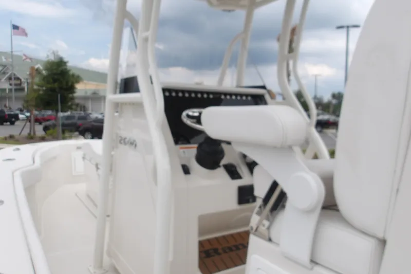 Slide: The Image of 2025 Ranger 2600 Bay boat interior with steering console and seating. - 11
