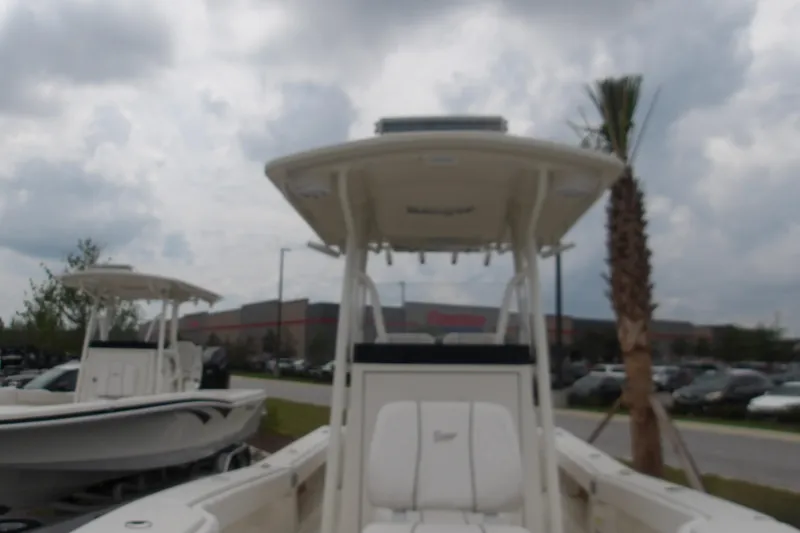 Slide: The Image of 2025 Ranger 2600 Bay boat displayed outdoors under cloudy sky. - 18