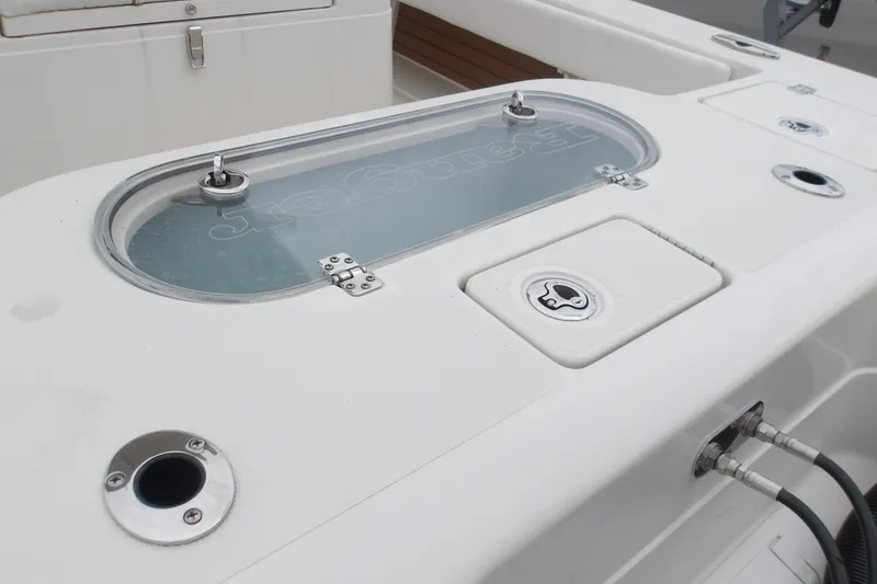 Slide: The Image of 2025 Ranger 2600 Bay boat deck with livewell and storage compartments. - 19