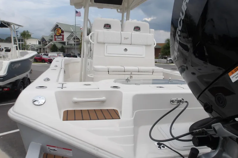 Slide: The Image of 2025 Ranger 2600 Bay boat with Mercury engine, displayed outdoors near Outdoor World. - 9