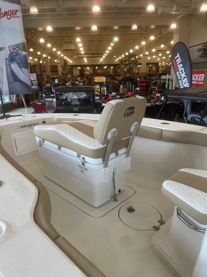 Slide: The Image of 2025 Ranger 2600 Bay boat interior at showroom, featuring seating and modern design. - 3