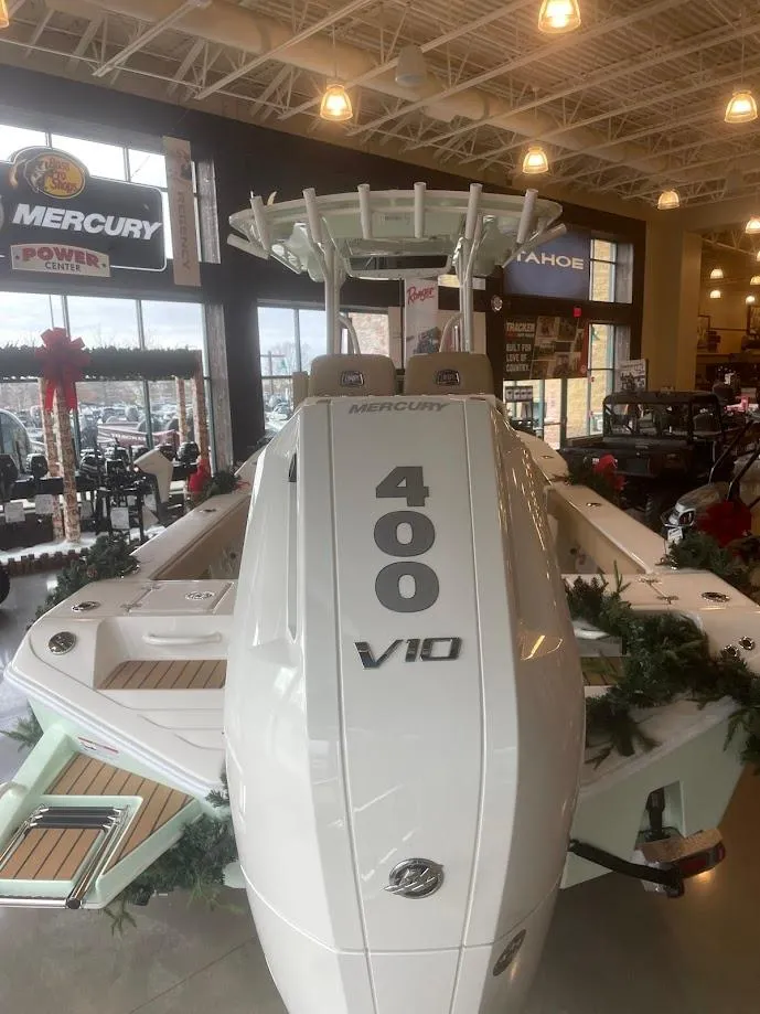 Slide: The Image of 2025 Ranger 2600 Bay boat with Mercury 400 V10 engine displayed indoors. - 6