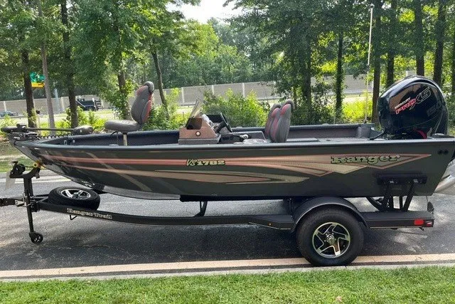 Slide: The Image of 2025 Ranger VS1782SC Angler boat on trailer, parked outdoors near trees. - 1
