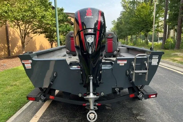 Slide: The Image of 2025 Ranger VS1782SC Angler boat with powerful outboard motor, parked on a street. - 2