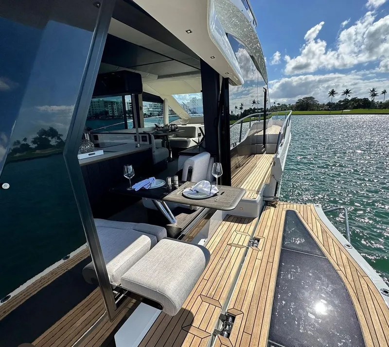 Slide: The Image of Luxury 2025 Galeon 560 Fly yacht with elegant deck dining setup. - 5