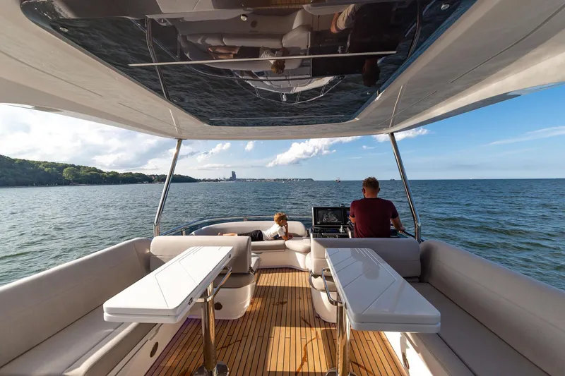 Slide: The Image of Galeon 560 Fly 2025 yacht cruising on open water, featuring spacious deck seating. - 7