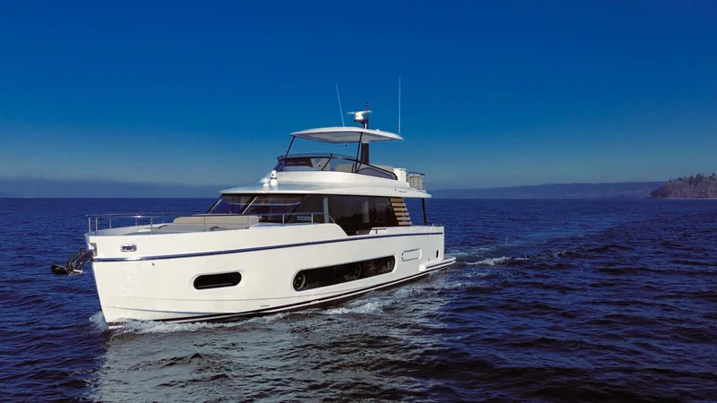 Slide: The Image of 2025 Azimut Magellano 60 yacht cruising on open sea under clear blue sky. - 1